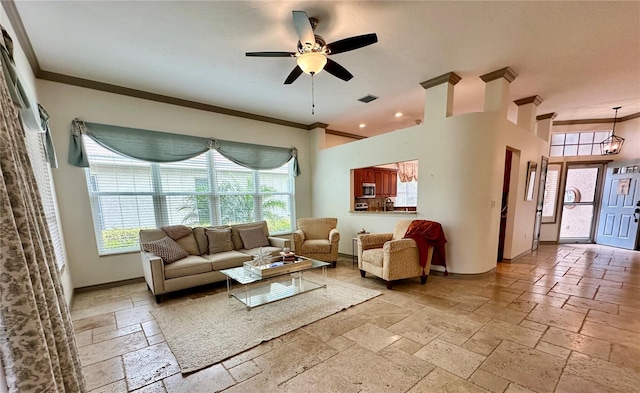 living room with ceiling fan and crown molding