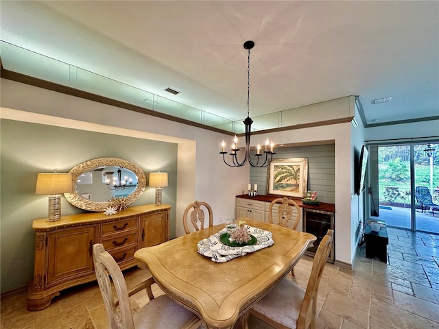 dining room featuring an inviting chandelier and crown molding