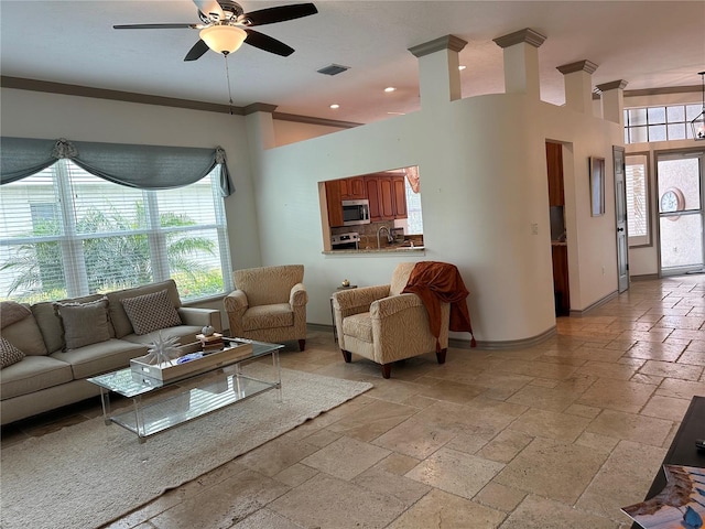 living room with ceiling fan and crown molding