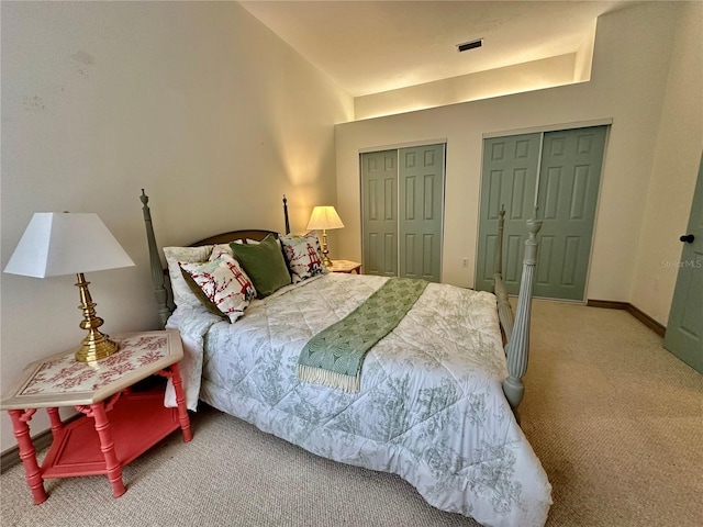 carpeted bedroom with multiple closets