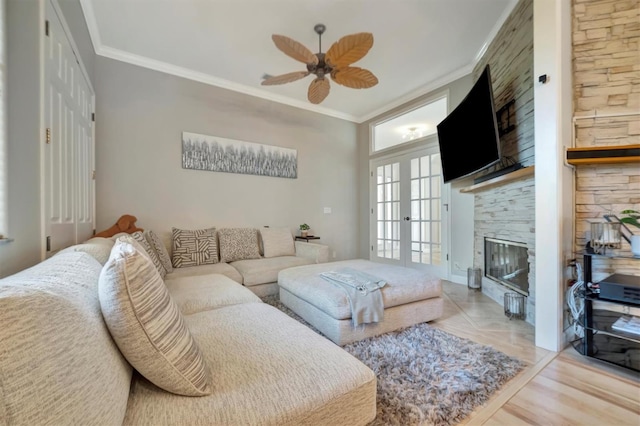 living room featuring light hardwood / wood-style floors, ornamental molding, french doors, and ceiling fan