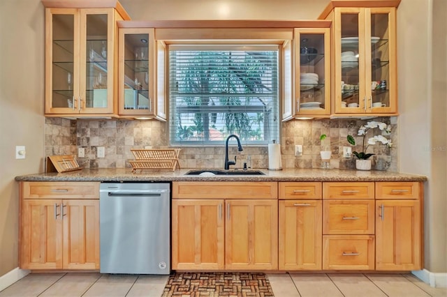 kitchen featuring light tile patterned floors, backsplash, sink, and dishwasher