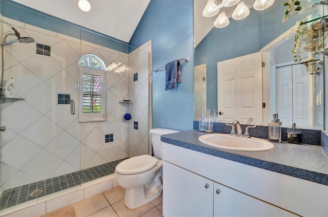 bathroom with a shower with door, toilet, vanity, tile patterned floors, and lofted ceiling