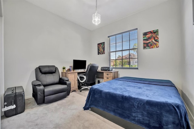 carpeted bedroom featuring a chandelier