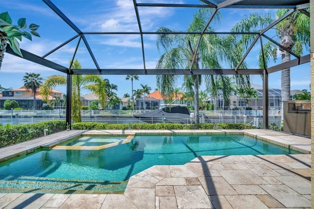 view of pool featuring an in ground hot tub, a patio area, and a lanai