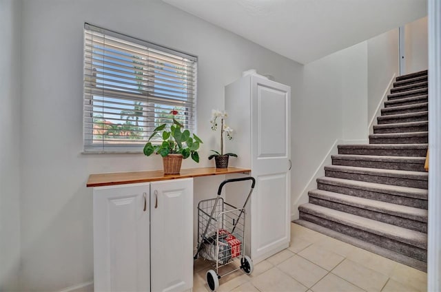 stairway featuring tile patterned floors