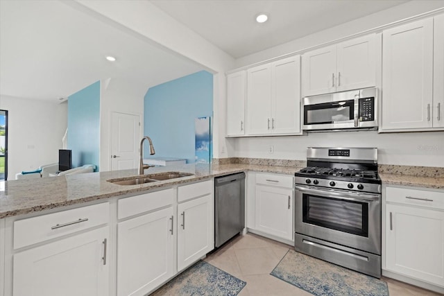 kitchen with sink, stainless steel appliances, and white cabinetry