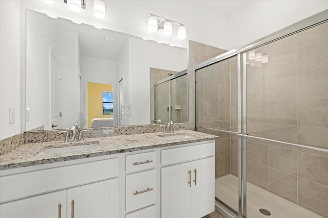 bathroom featuring vanity and a shower with door