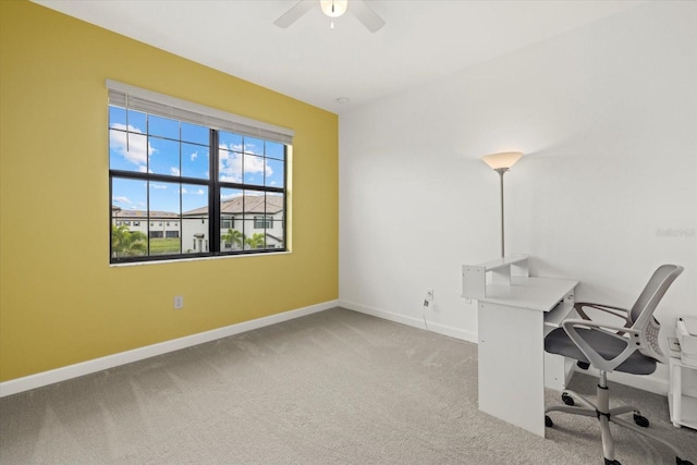 unfurnished office featuring ceiling fan and light colored carpet