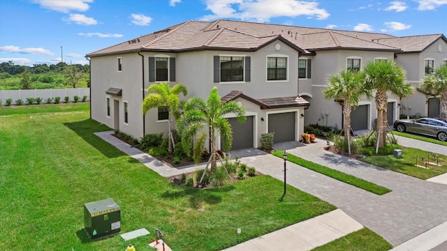 view of front of home with a garage and a front lawn