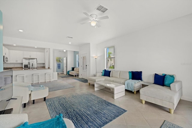 tiled living room with ceiling fan