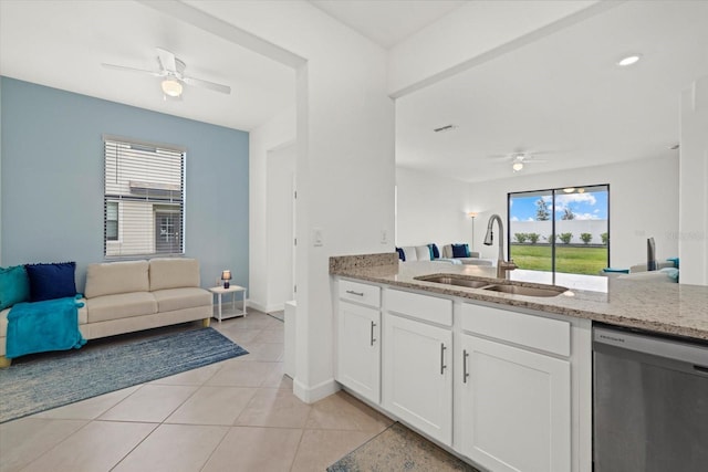 kitchen featuring sink, stainless steel dishwasher, white cabinets, and a wealth of natural light