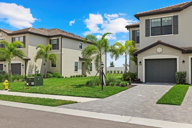 view of front of property with a garage and a front yard