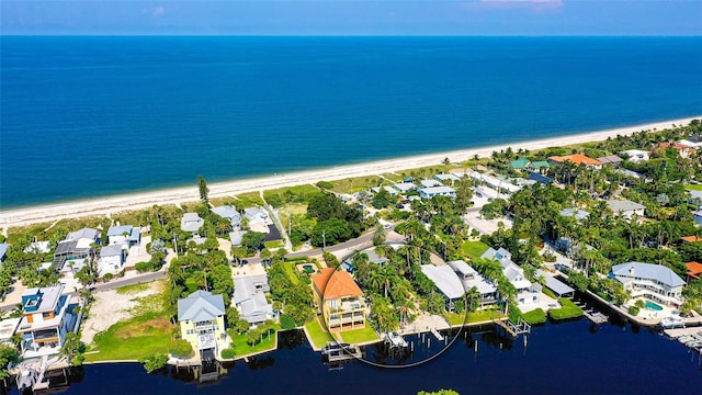 drone / aerial view featuring a beach view and a water view