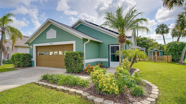 view of front of property with a garage and a front lawn