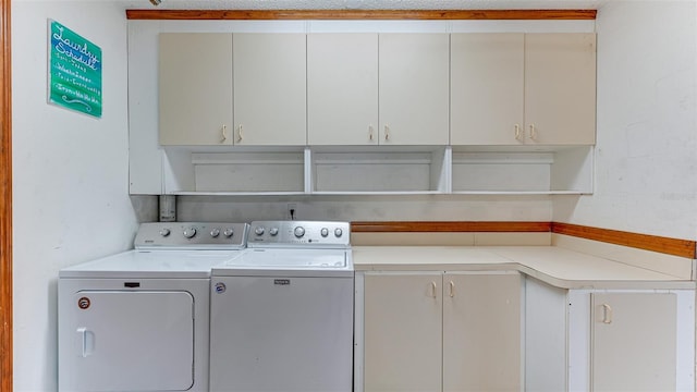 laundry room with cabinets and washer and dryer