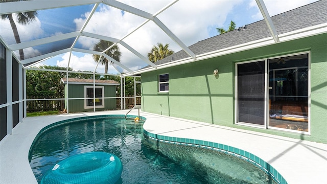 view of pool with an outbuilding and a lanai