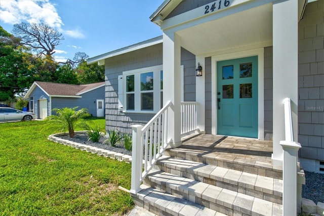 entrance to property with a lawn