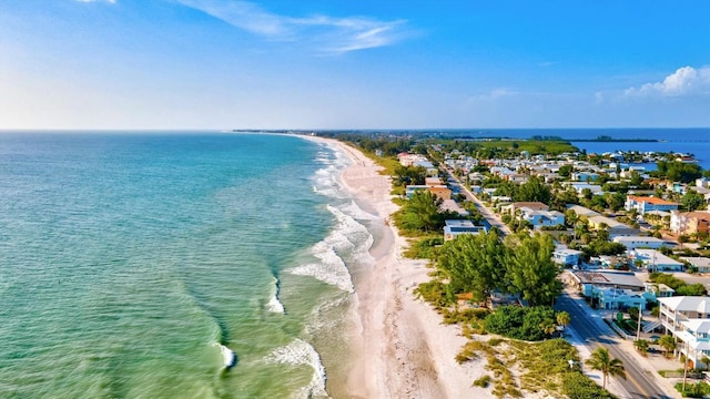 birds eye view of property with a beach view and a water view