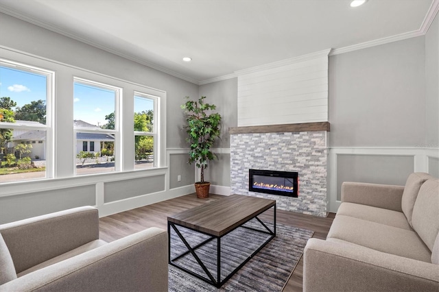 living room featuring a fireplace, hardwood / wood-style floors, and crown molding