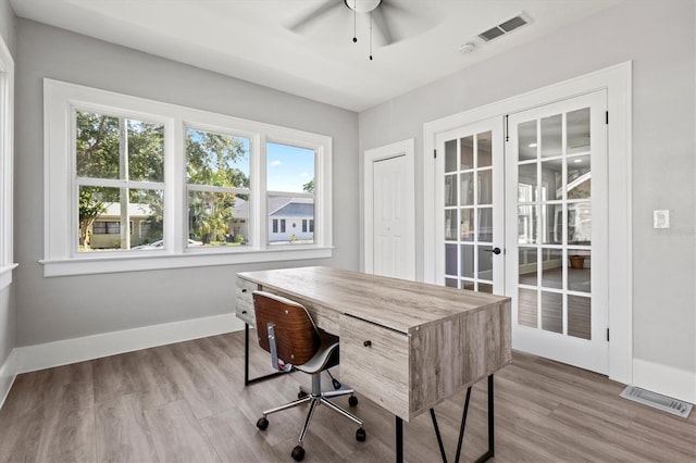 office area with ceiling fan, light hardwood / wood-style flooring, and french doors