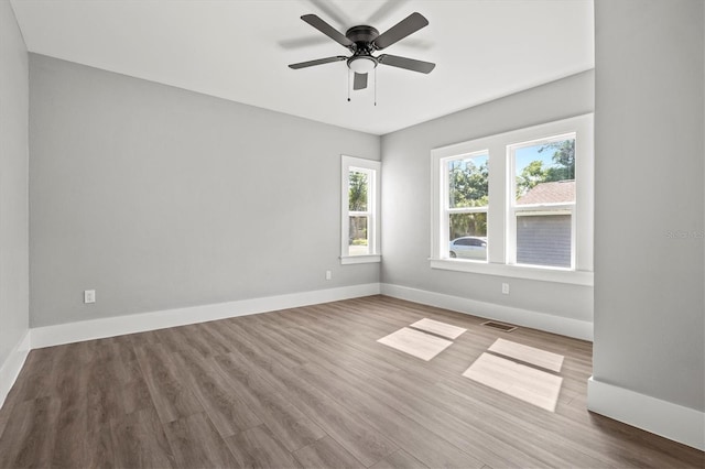 unfurnished room featuring hardwood / wood-style flooring and ceiling fan