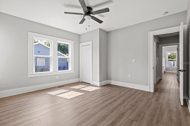 unfurnished bedroom with ceiling fan and light wood-type flooring