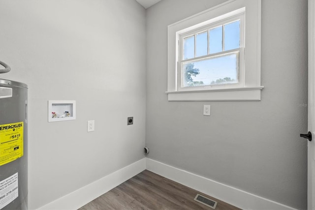 clothes washing area with hookup for an electric dryer, hookup for a washing machine, water heater, and dark hardwood / wood-style floors