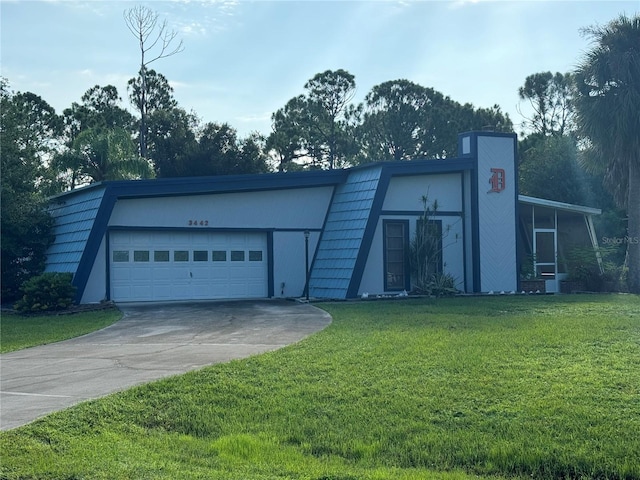 view of front of property with a front lawn and a garage