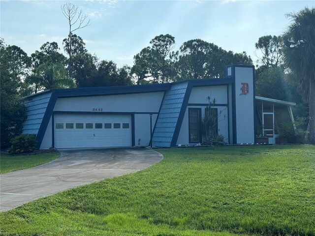 view of front of home featuring a garage and a front lawn