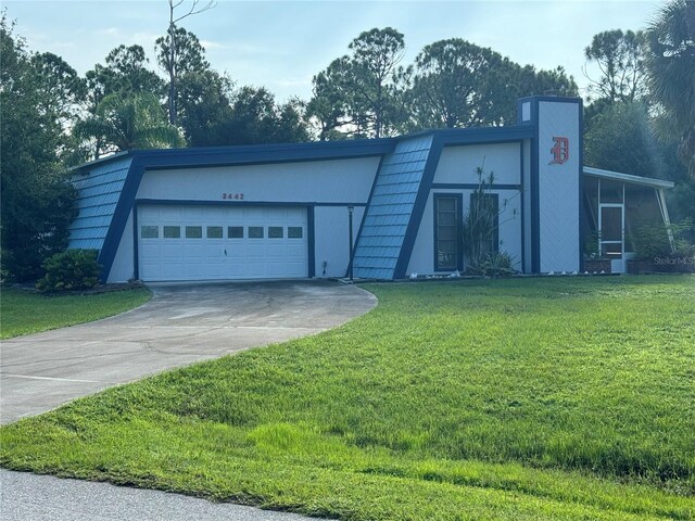 exterior space featuring a garage and a front lawn