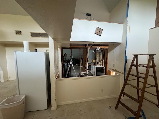 kitchen featuring light tile patterned floors and white refrigerator