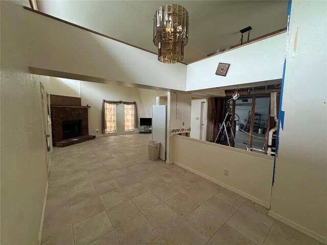 living room featuring an inviting chandelier and a fireplace