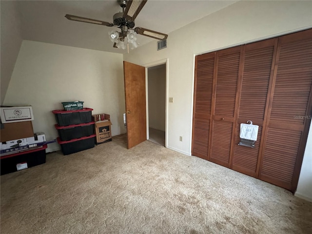 unfurnished bedroom featuring carpet flooring, ceiling fan, and a closet