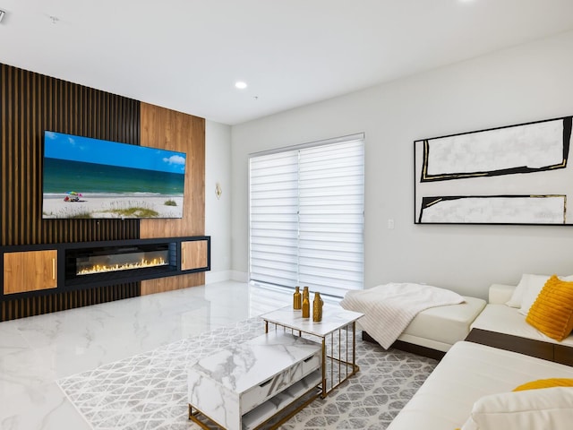 living room with a glass covered fireplace, marble finish floor, visible vents, and recessed lighting