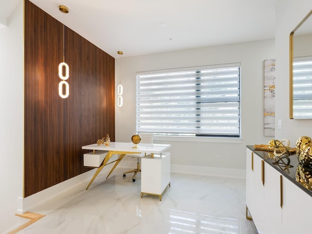 home office with marble finish floor and baseboards