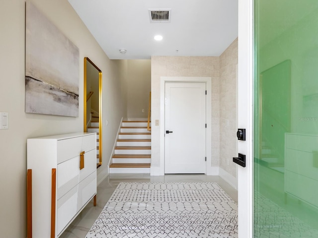 interior space featuring recessed lighting, visible vents, baseboards, and stairs