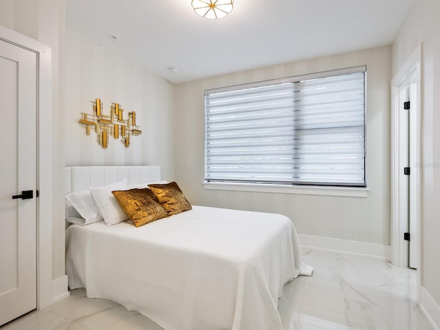 bedroom with marble finish floor and baseboards