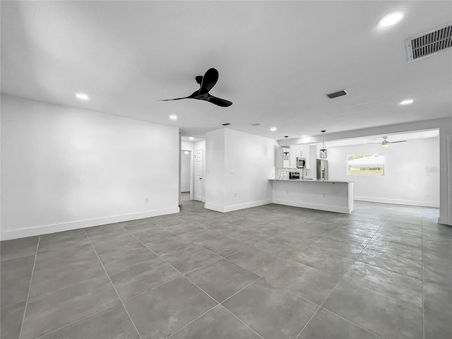 unfurnished living room with ceiling fan, recessed lighting, and visible vents