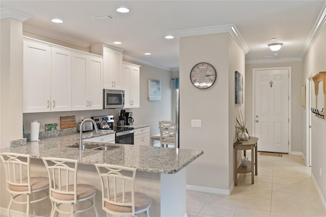 kitchen featuring appliances with stainless steel finishes, white cabinetry, and a peninsula