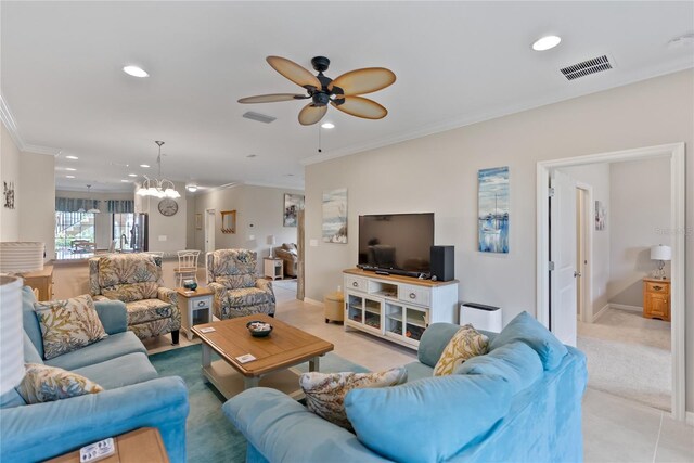 tiled living room featuring ceiling fan with notable chandelier and ornamental molding