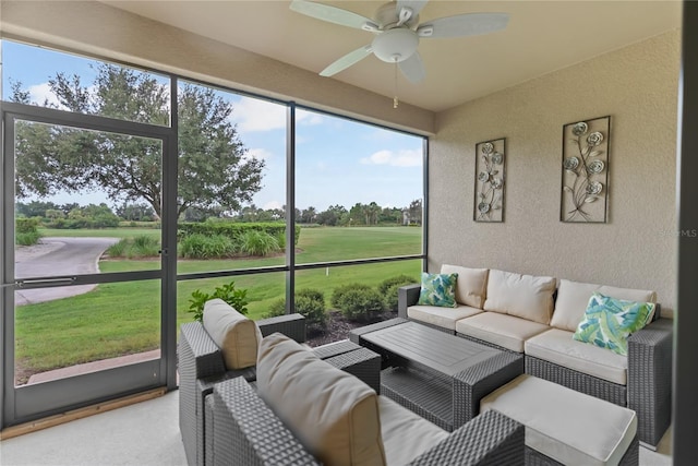 sunroom / solarium featuring a ceiling fan