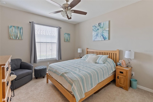 bedroom featuring ceiling fan, baseboards, and light colored carpet