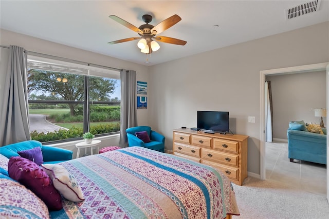 tiled bedroom featuring ceiling fan