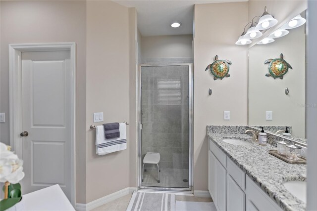 bathroom with tile patterned flooring, a shower with door, and dual bowl vanity