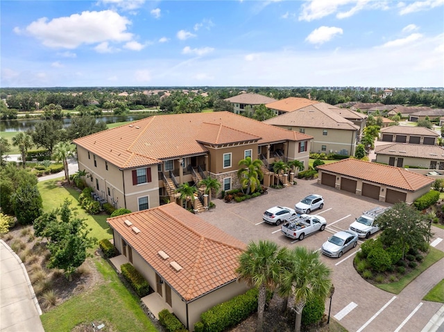 birds eye view of property with a water view and a residential view