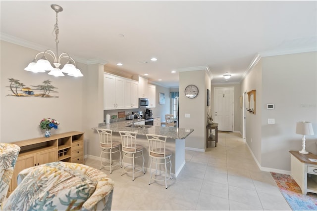 kitchen featuring appliances with stainless steel finishes, sink, light stone counters, light tile patterned floors, and kitchen peninsula