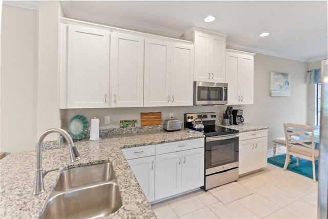 kitchen with stainless steel appliances, white cabinetry, sink, crown molding, and light tile patterned floors