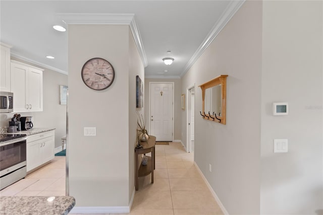 interior space with light tile patterned floors, appliances with stainless steel finishes, ornamental molding, and light stone counters