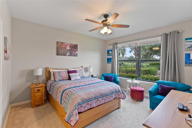 bedroom with baseboards, ceiling fan, and light colored carpet